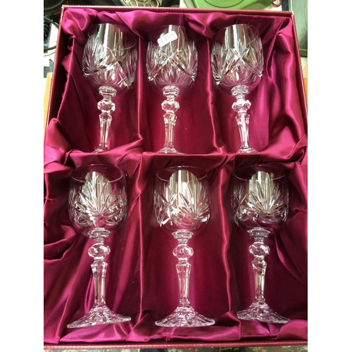 485 - A CASED COLLECTION OF SIX CUT GLASS CRYSTAL WINE GLASSES AND A TEAK CASED CANTEEN OF CUTLERY