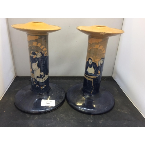 504 - PAIR OF MATCHING ROYAL DOULTON CANDLESTICKS WITH MONK SCENES (BOTH A/F)