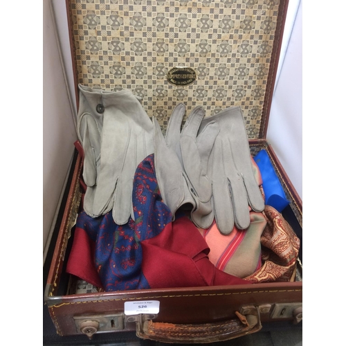 526 - A VINTAGE BROWN LEATHER SUITCASE CONTAINING SILK SCARVES AND LEATHER GLOVES