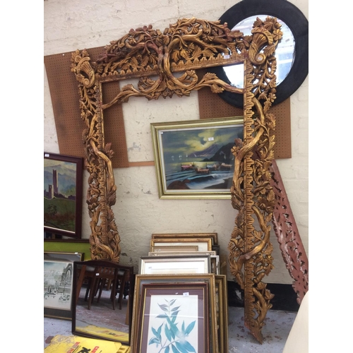 556 - A LARGE ORNATE GILT FRAME (MEASURING 85