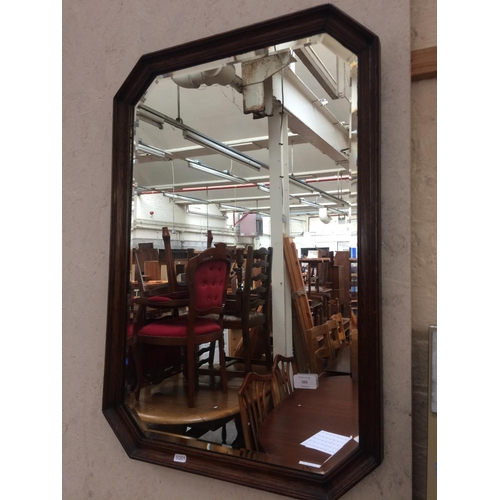 563 - AN OAK FRAMED BEVEL EDGE MIRROR