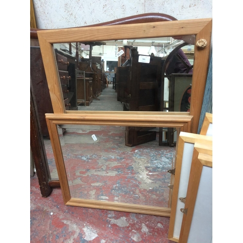 581 - TWO PINE FRAMED MIRRORS AND A MAHOGANY FRAMED MIRROR