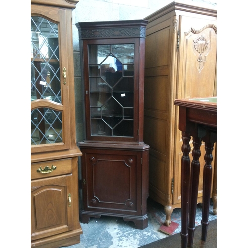 591 - A MAHOGANY FREE STANDING CORNER CABINET WITH ONE LOWER DOOR, ONE UPPER GLAZED DOOR AND THREE INNER S... 