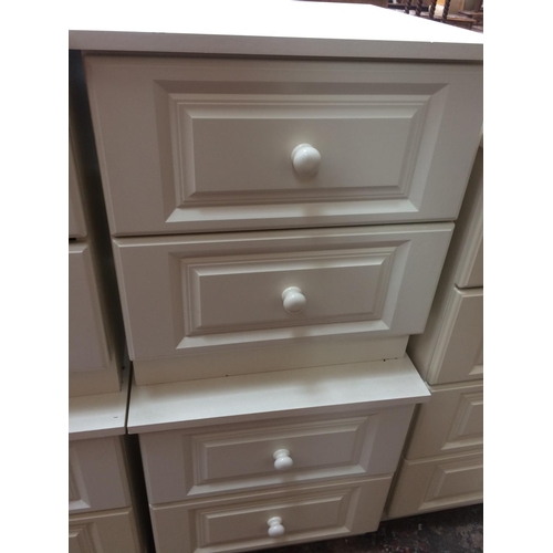 608 - TWO MODERN WHITE BEDSIDE CHESTS OF TWO DRAWERS