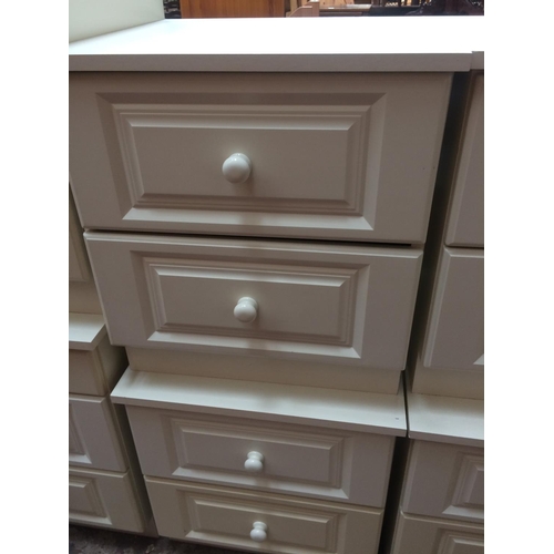 609 - TWO MODERN WHITE BEDSIDE CHESTS OF TWO DRAWERS