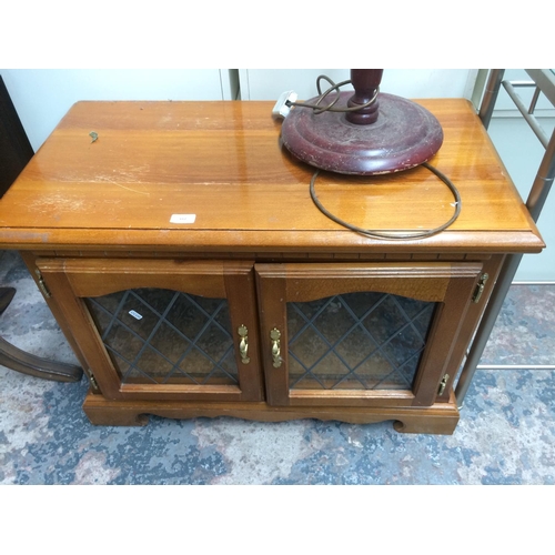 617 - A TEAK MEDIA UNIT WITH TWO LOWER GLAZED DOORS