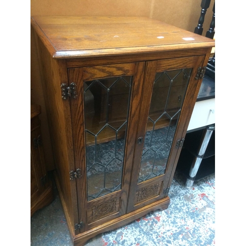 637 - A GOOD QUALITY JAYCEE OAK STEREO CABINET WITH TWO LEADED GLASS DOORS AND HINGED LID