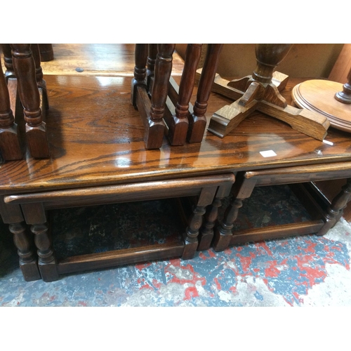 644 - A GOLDEN OAK COFFEE TABLE WITH TWO NESTING TABLES