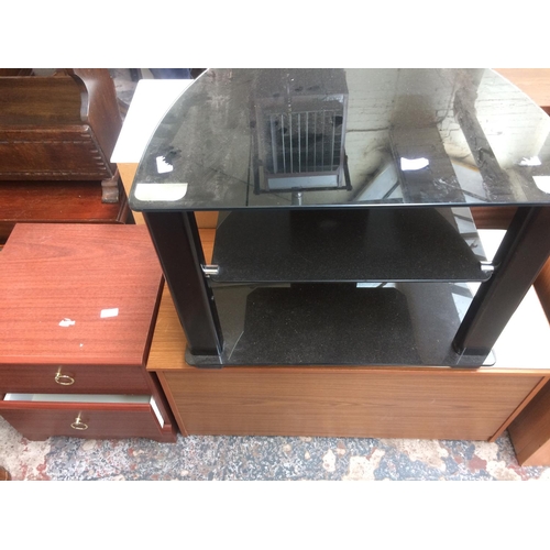 654 - THREE ITEMS TO INCLUDE A BLACK GLASS TV STAND, MAHOGANY EFFECT CHEST OF TWO DRAWERS AND A TELEPHONE ... 