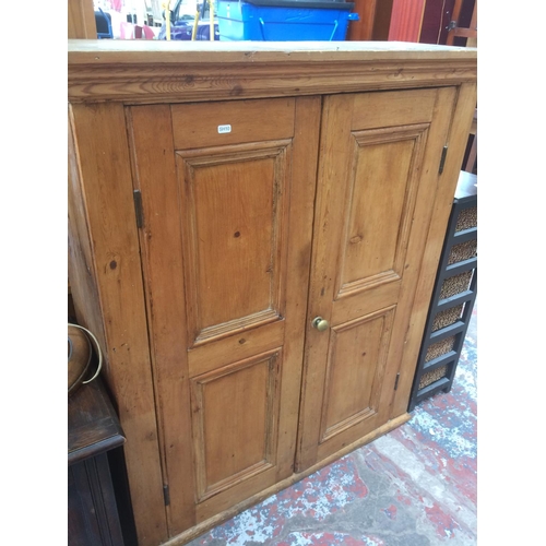 671 - A VICTORIAN PINE SCHOOL CABINET WITH TWO DOORS (MEASURING 46