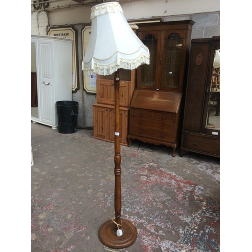 672 - A MAHOGANY STANDARD LAMP AND SHADE