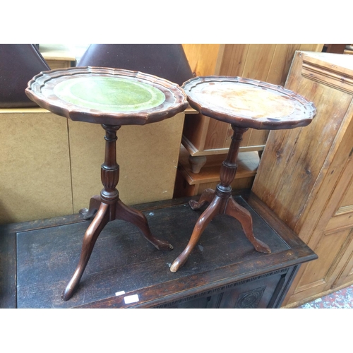 673 - TWO MAHOGANY WINE TABLES WITH LEATHER INSERTS