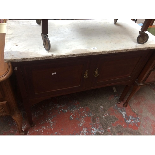 677 - A MAHOGANY MARBLE TOP WASHSTAND WITH TWO DOORS