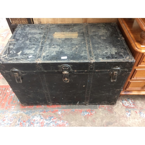 706 - A LARGE VINTAGE BLACK PAINTED TRAVELLING TRUNK