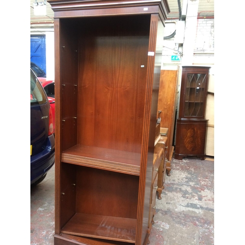 717 - A MAHOGANY FREE STANDING BOOKCASE WITH FIVE SHELVES