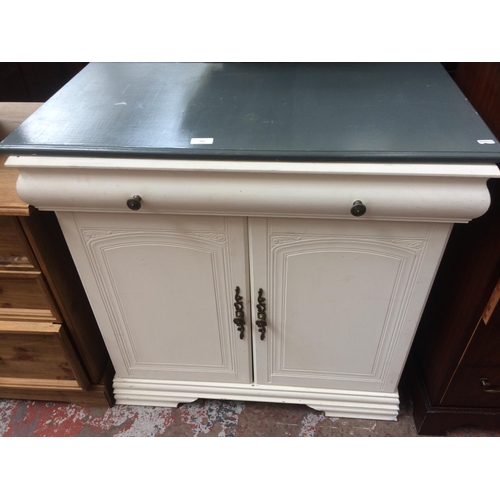 720 - A WHITE PAINTED TWO DOOR CABINET WITH ONE DRAWER