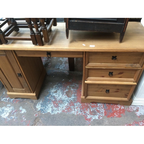 722 - A MODERN PINE DESK WITH THREE DRAWERS, ONE DOOR AND A PULL OUT KEYBOARD TRAY