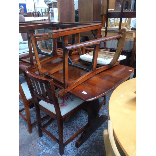 738 - AN ERCOL ELM DINING TABLE AND SIX MATCHING CHAIRS