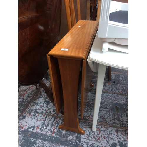 740 - A SMALL TEAK DROP LEAF DINING TABLE AND TWO MATCHING CHAIRS