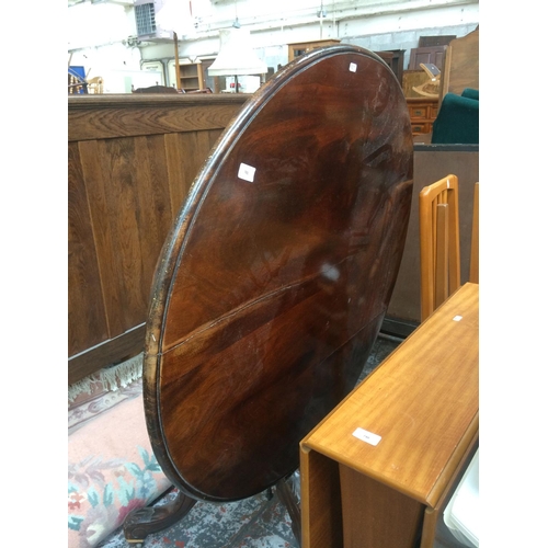 741 - AN ANTIQUE STYLE MAHOGANY CIRCULAR DINING TABLE TOGETHER WITH TWO ELM SEATED DINING CHAIRS