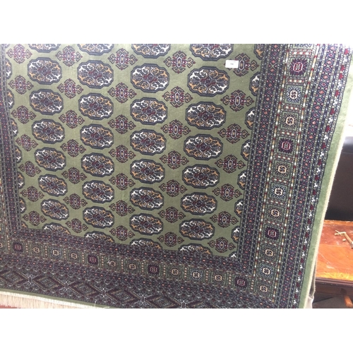 746 - A GREEN GROUND BOKHARA RUG MEASURING 2m x 1.4m