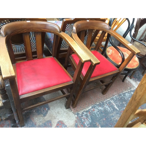 778 - A PAIR OF VINTAGE 1920'S OAK FRAMED OFFICE TUB CHAIRS WITH RED LEATHERETTE SEATS