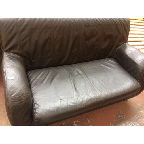 797 - A BLACK LEATHER BED SETTEE