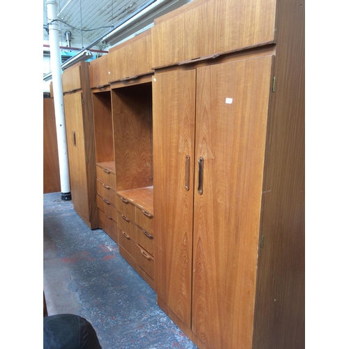 798 - A VINTAGE MID-CENTURY J.S. SAKOL TEAK BEDROOM SUITE COMPRISING OF THREE DOUBLE DOOR WARDROBES, TWO D... 