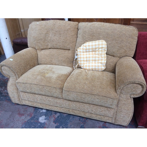 807 - A CREAM UPHOLSTERED TWO SEATER SOFA