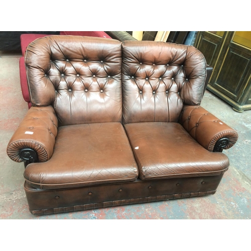 810 - A BROWN LEATHERETTE TWO SEATER SOFA