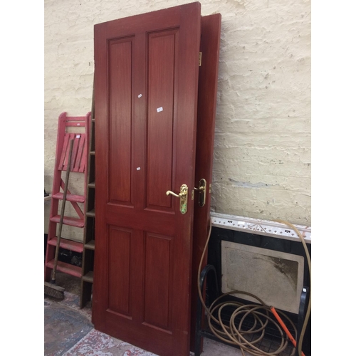 86 - FOUR VARIOUS SIZED GOOD QUALITY HARDWOOD INTERIOR PANEL DOORS WITH BRASS FURNITURE