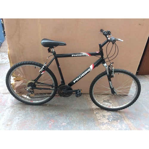 9 - A BLACK PROBIKE PHOENIX MENS MOUNTAIN BIKE WITH FRONT SUSPENSION AND 18 SPEED SHIMANO GEAR SYSTEM