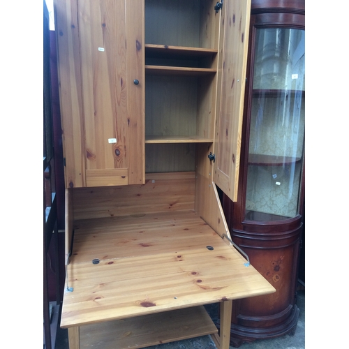 710 - A MODERN PINE BUREAU BOOKCASE WITH TWO UPPER DOORS, ONE DRAWER AND FALL FRONT