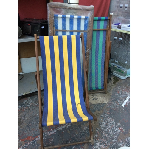 38 - THREE TRADITIONAL WOODEN DECK CHAIRS WITH STRIPPED UPHOLSTERY