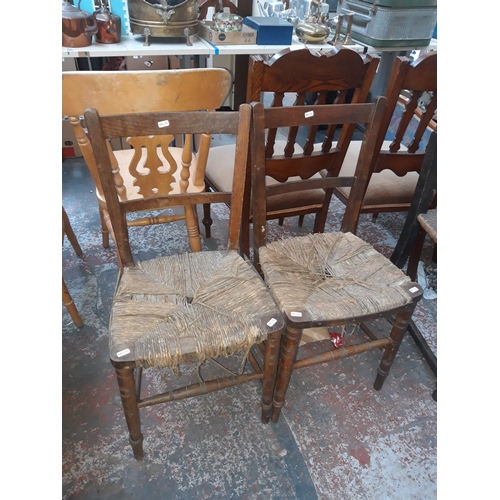 779A - A PAIR OF VINTAGE OAK FRAMED DINING CHAIRS ON BARLEY TWIST SUPPORTS WITH RUSH SEATS