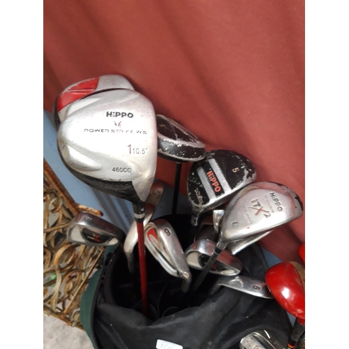 106 - TWO GOLF BAGS AND A TROLLEY CONTAINING ZIPPO, POWER STRIKE AND SPALDING GOLF CLUBS