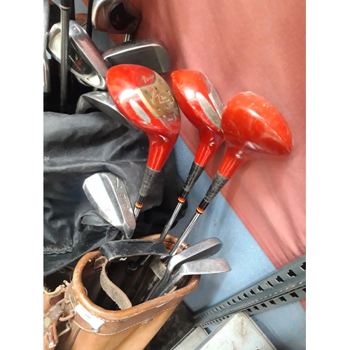 106 - TWO GOLF BAGS AND A TROLLEY CONTAINING ZIPPO, POWER STRIKE AND SPALDING GOLF CLUBS