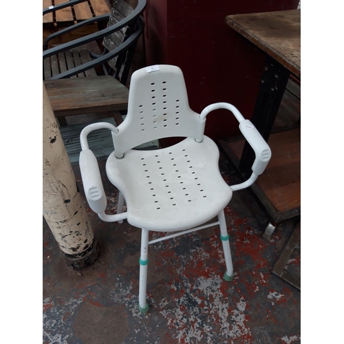 23 - A WHITE SHOWER CHAIR