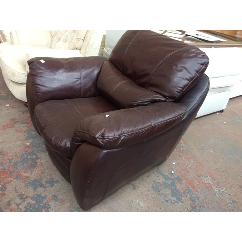 756 - A BROWN LEATHER ARMCHAIR