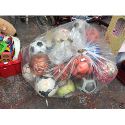 17 - A VERY LARGE BAG OF VARIOUS STYLED FOOTBALLS AND RUGBY BALLS