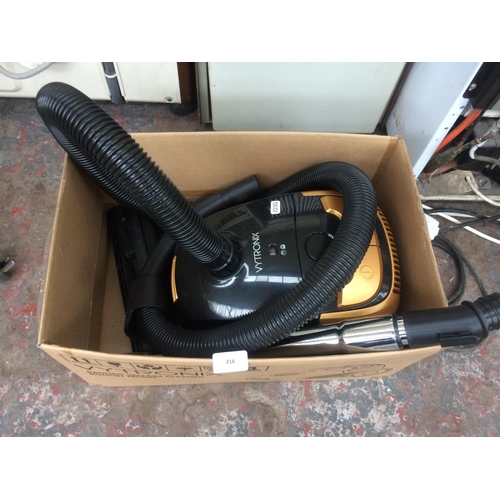 218 - A BLACK AND GOLD VYTRONIX CYLINDER VACUUM CLEANER WITH ATTACHMENTS