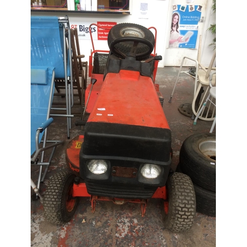 22 - A RED WESTWOOD T1200 12 HORSE POWER RIDE ON TRACTOR LAWN MOWER WITH SPARE WHEELS, GRASS COLLECTOR AN... 