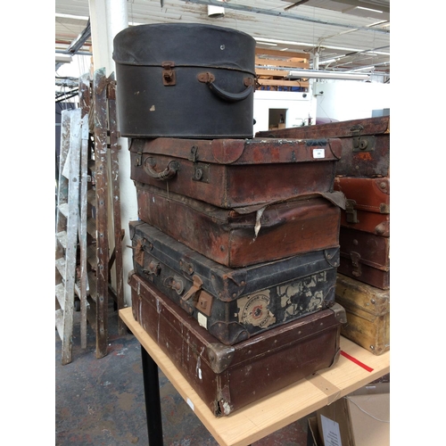 339 - FOUR VINTAGE LEATHER SUITCASES AND A HAT BOX