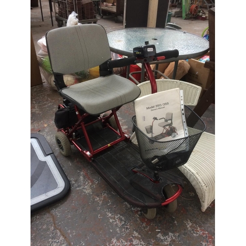 34 - A BLACK AND RED ULTRALITE THREE WHEELED ELECTRIC MOBILITY SCOOTER WITH BATTERY, CHARGER AND INSTRUCT... 