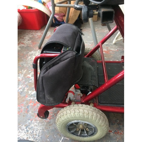 34 - A BLACK AND RED ULTRALITE THREE WHEELED ELECTRIC MOBILITY SCOOTER WITH BATTERY, CHARGER AND INSTRUCT... 