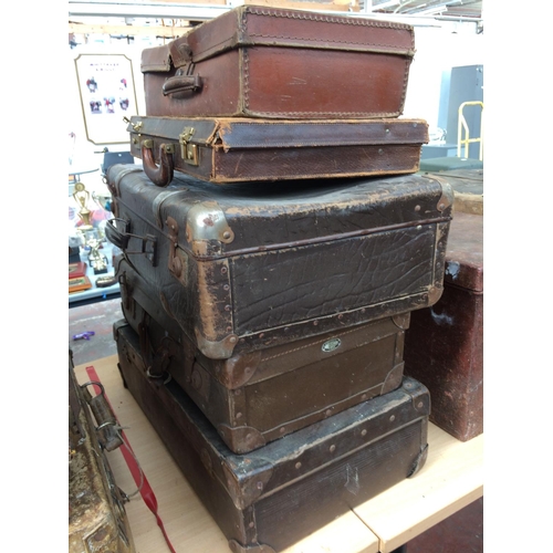 341 - FOUR VINTAGE LEATHER SUITCASES AND A SMALL LEATHER BRIEFCASE