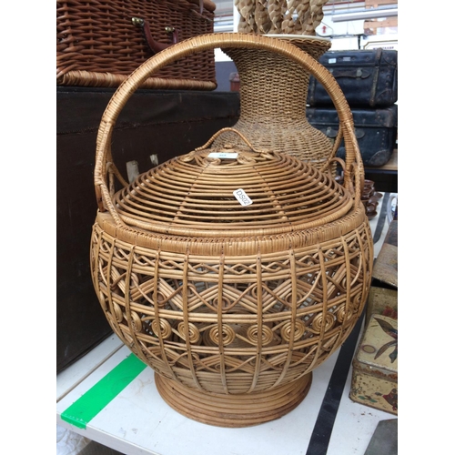 369 - AN ORNATE WICKER LIDDED BASKET AND A WICKER VASE WITH CONTENTS