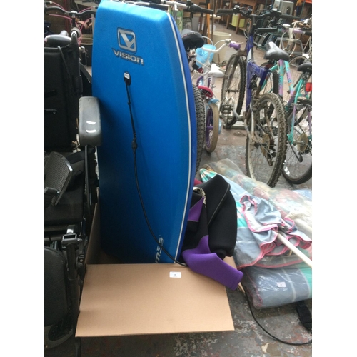 39 - A BOX CONTAINING A BLUE VISION VENOM 42 BODYBOARD, TWO FULL LENGTH WINTER GUL WETSUITS (ONE SIZE L A... 