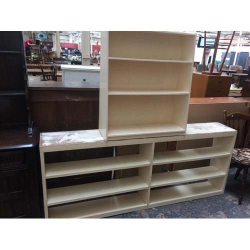 537 - THREE ELM FARMHOUSE KITCHEN CHAIRS AND TWO WHITE PAINTED BOOKCASES