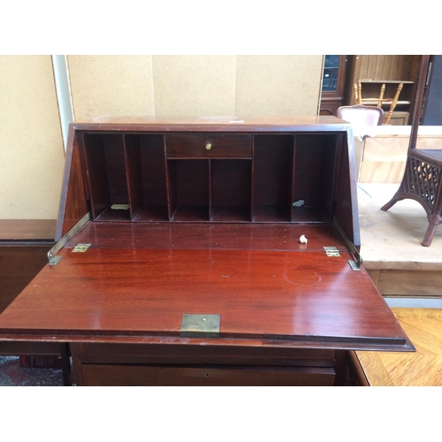 579 - A GOOD QUALITY INLAID MAHOGANY BUREAU WITH THREE DRAWERS AND FALL FRONT ON BRACKET FEET